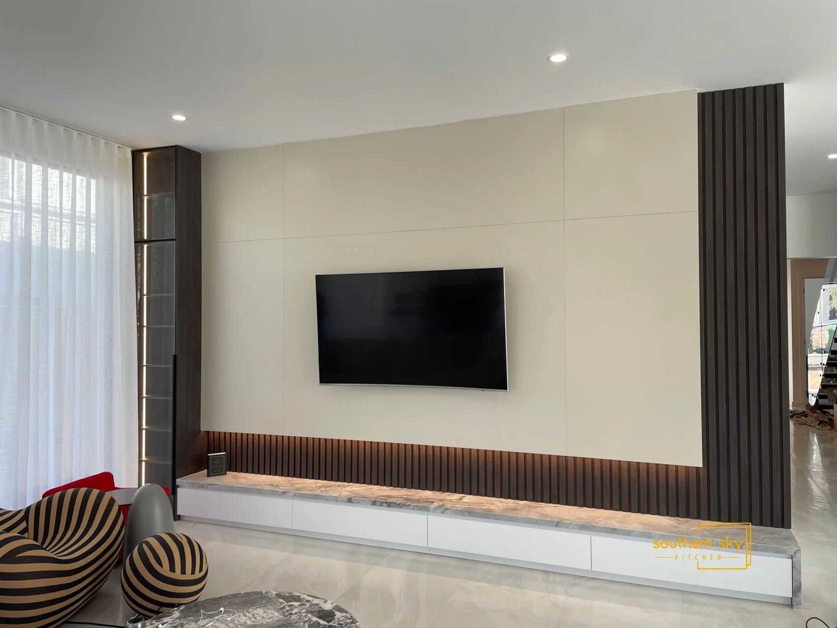 Sleek entertainment wall unit showcasing expert craftsmanship, modern design, and elegant finishes; enhances any living space.