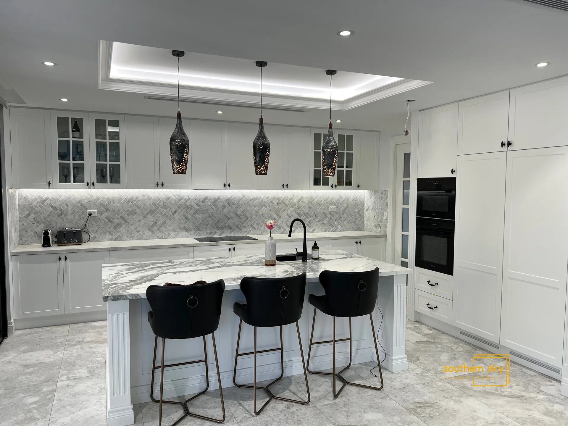 Luxurious kitchen with exquisite marble countertops, sleek cabinetry, and designer lighting for unmatched style and elegance.