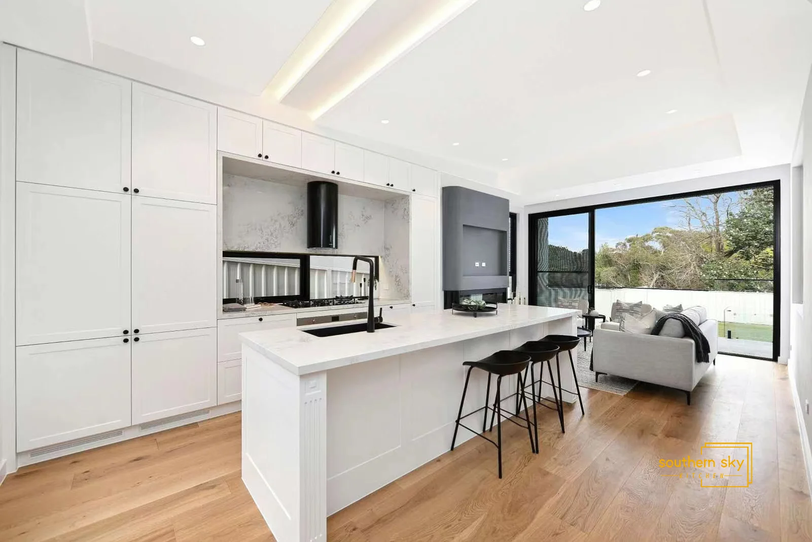 Sleek modern kitchen with exquisite craftsmanship, elegant white cabinetry, and airy design for ultimate style and functionality.