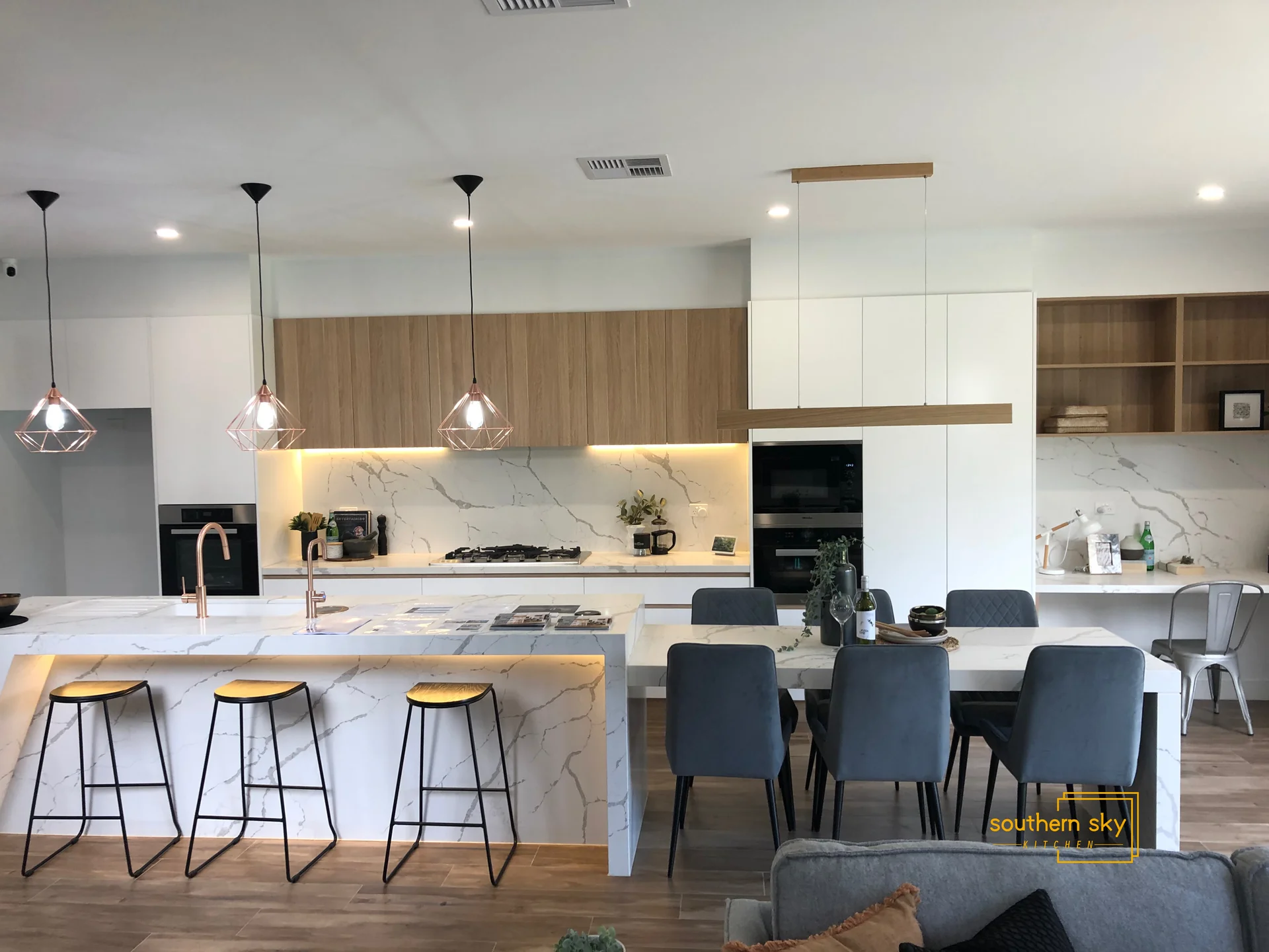 Luxurious kitchen design with exquisite marble countertops, elegant pendant lighting, and sleek cabinetry showcasing refined craftsmanship.