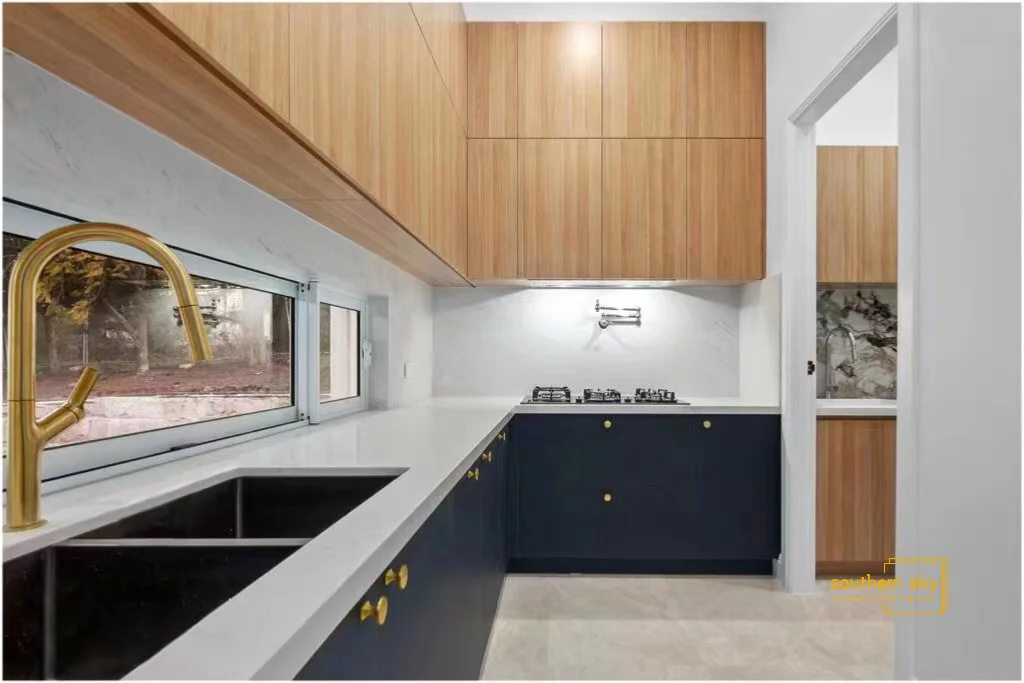 Luxurious kitchen with exquisite cabinetry, sleek countertops, and elegant brass fixtures, showcasing modern design excellence.