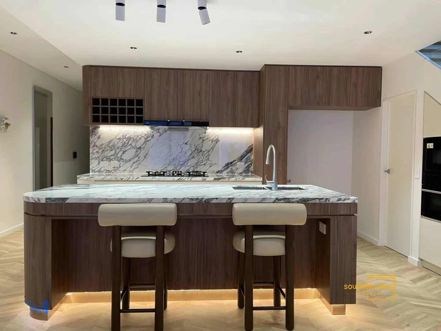 Luxurious kitchen with exquisite marble countertops and sleek wood cabinetry, showcasing exceptional craftsmanship and design.