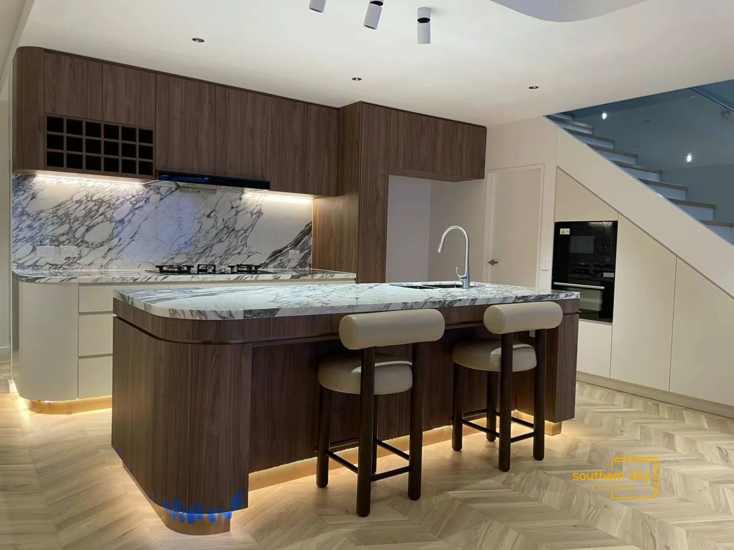 Luxurious kitchen with exquisite marble countertops and sleek wood cabinetry, showcasing masterful craftsmanship and modern elegance.