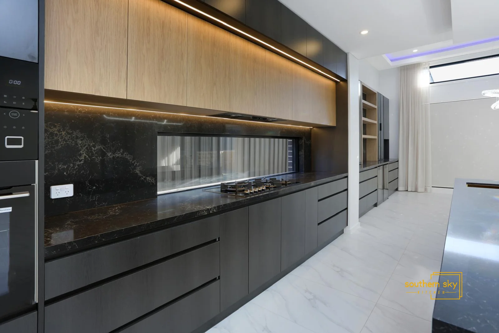 Sleek modern kitchen with high-end black marble counters and premium cabinetry, showcasing exquisite craftsmanship and style.