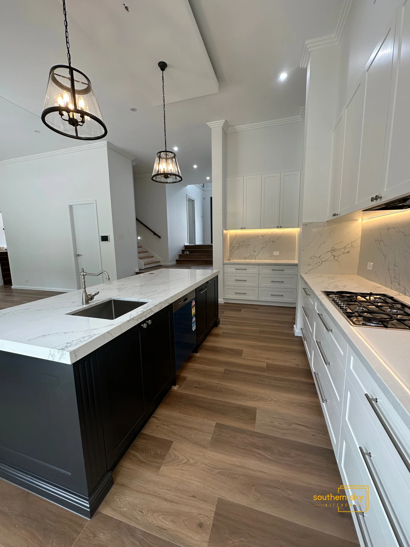 Luxuriate in exquisite kitchen design; sleek countertops, elegant lighting, and fine craftsmanship for modern living.