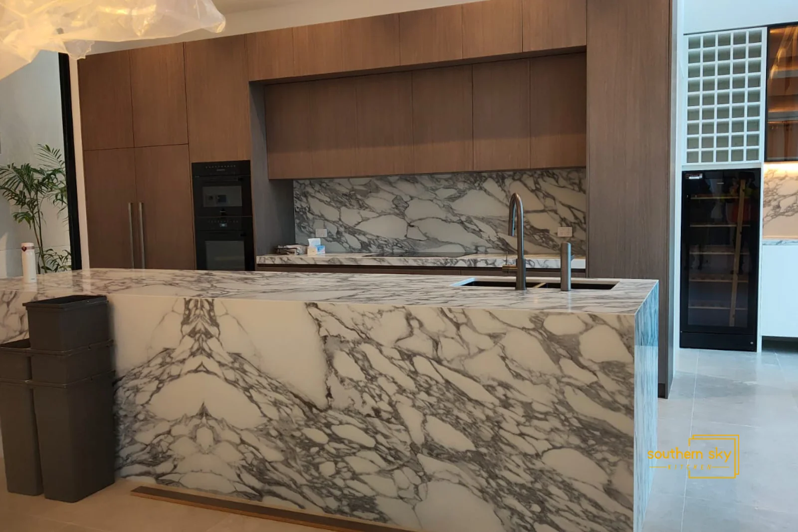 Luxurious marble kitchen with sleek, modern design; impeccable craftsmanship and aesthetic appeal for elegant homes.