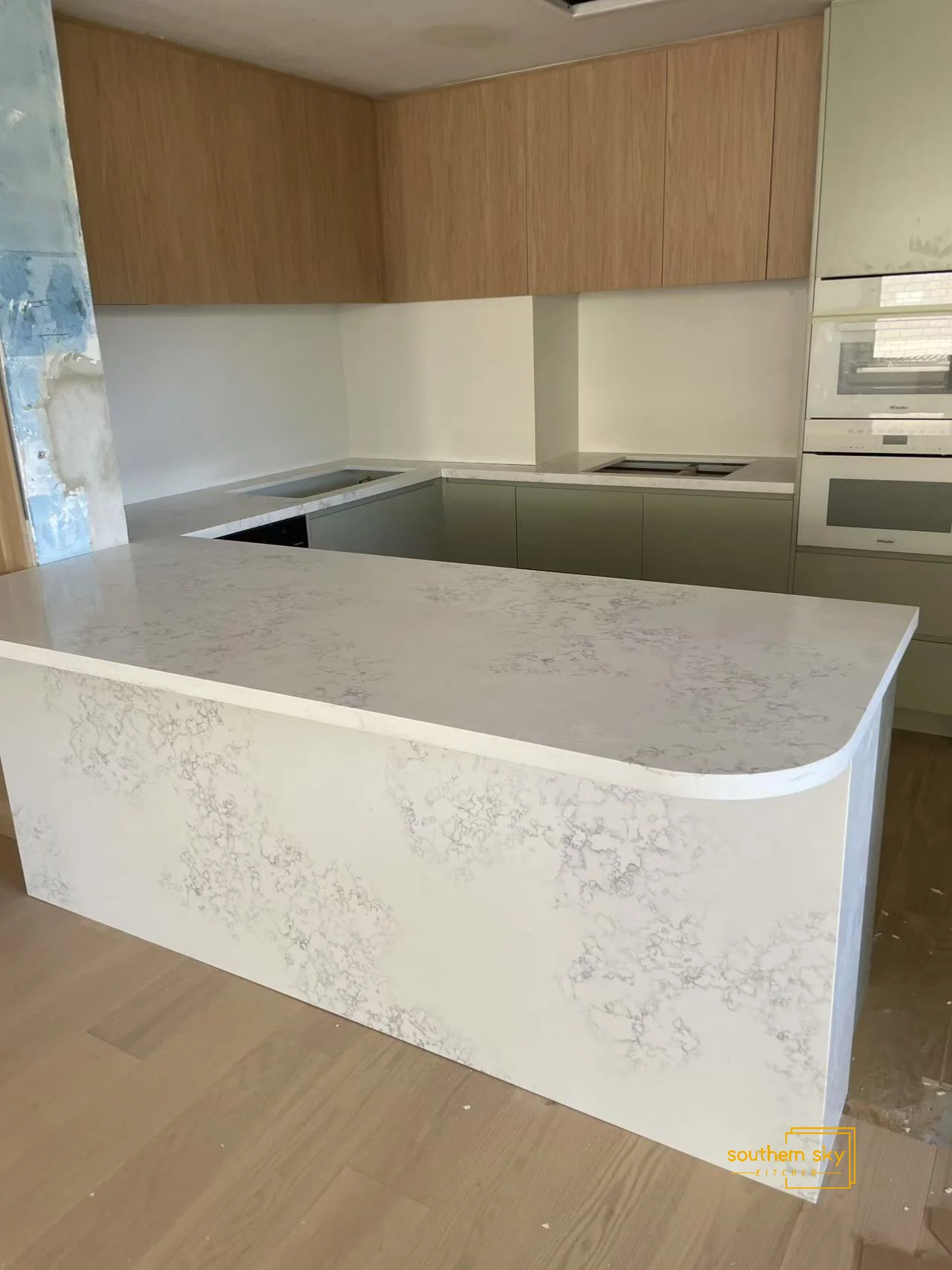 Sleek kitchen design featuring elegant marble-look countertops, seamless cabinetry, and premium craftsmanship for modern living.