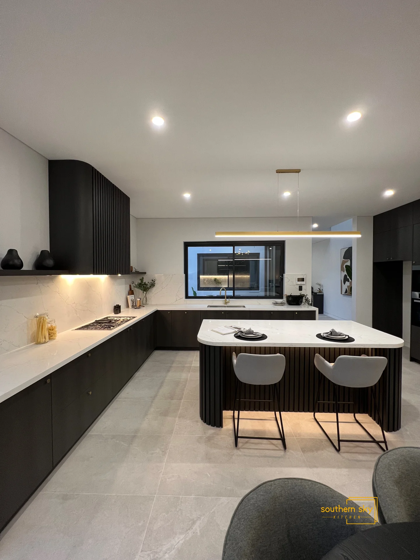 Sleek kitchen design with premium finishes, modern cabinetry, and elegant lighting; a masterpiece of style and functionality.