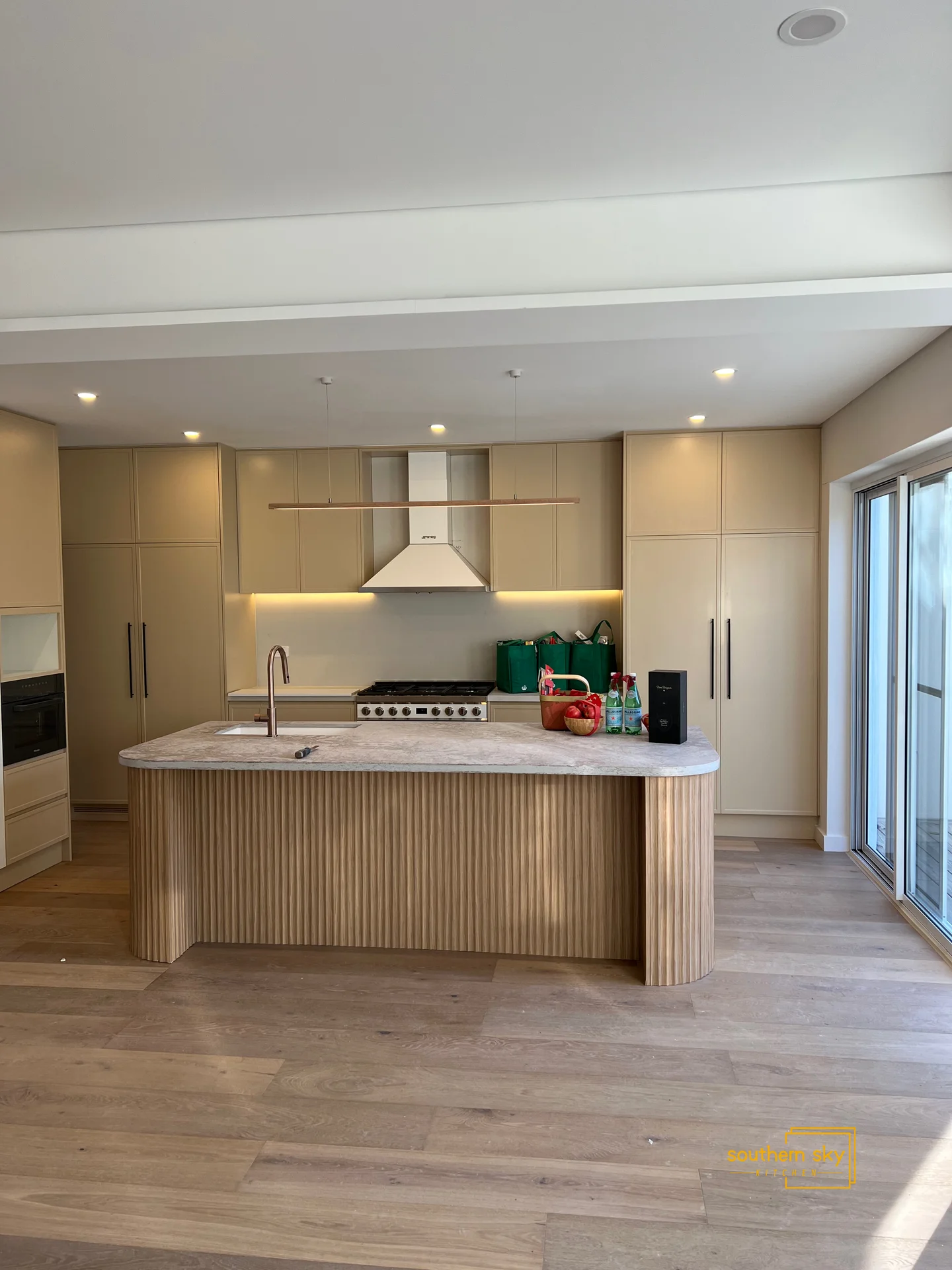 Sleek modern kitchen with exquisite craftsmanship, showcasing elegant cabinetry and a stylish, functional island centerpiece.