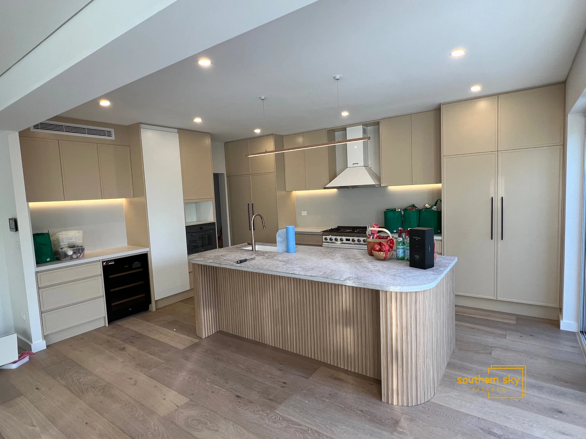 Sleek modern kitchen with exquisite craftsmanship, elegant cabinetry, and a stunning island centerpiece for ultimate sophistication.