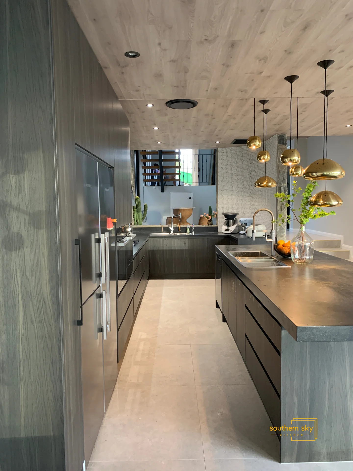 Luxurious kitchen design featuring sleek cabinetry, elegant gold pendant lighting, and impeccable modern finishes.