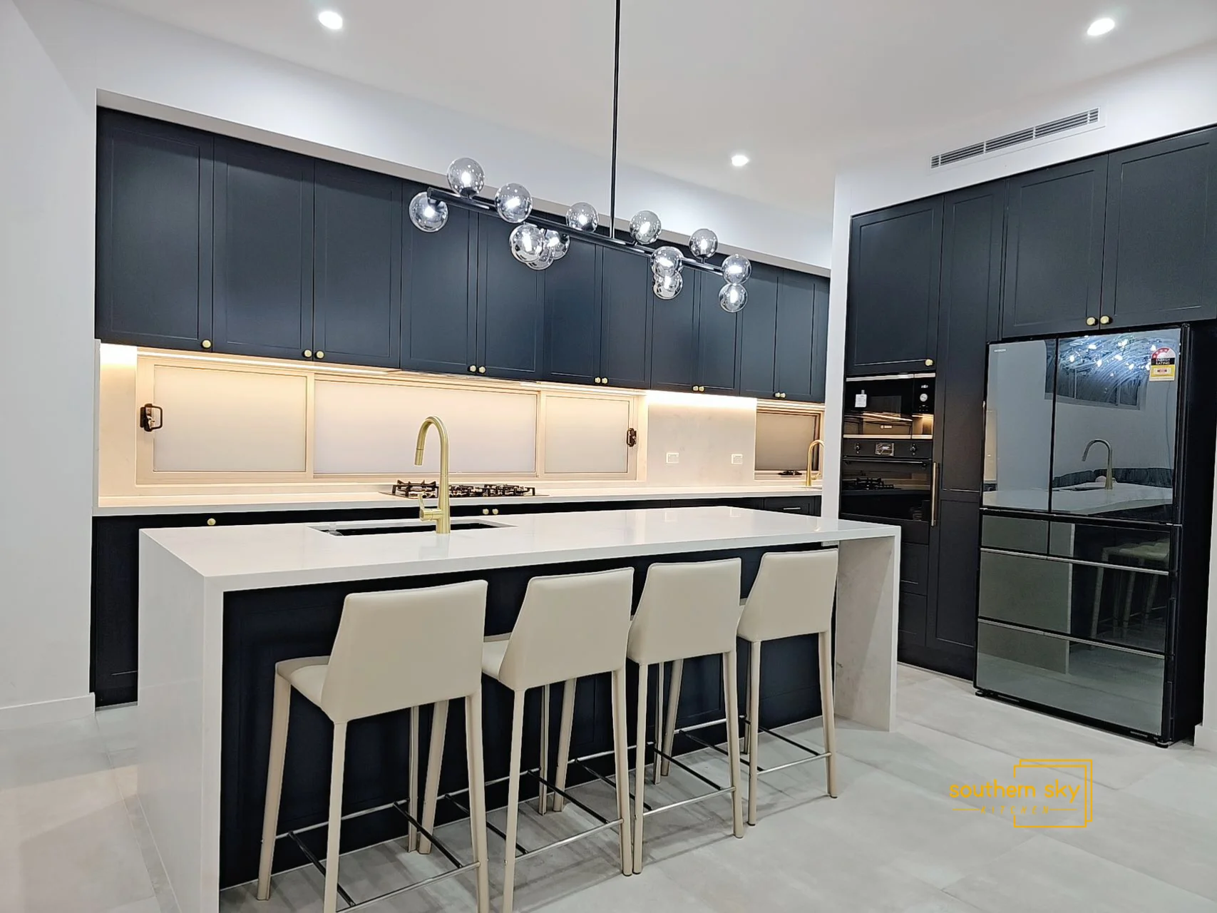 Modern kitchen design with sleek cabinetry, elegant lighting, and high-end finishes. Perfect blend of style and functionality.