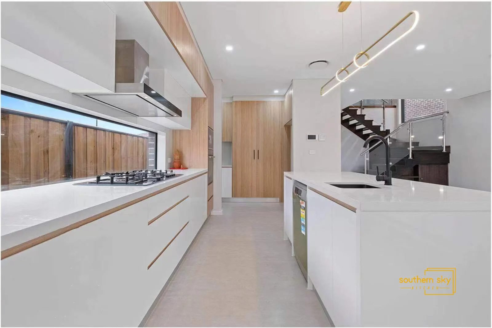 Sleek kitchen design with premium materials, modern fixtures, and elegant wood accents for a sophisticated, functional space.