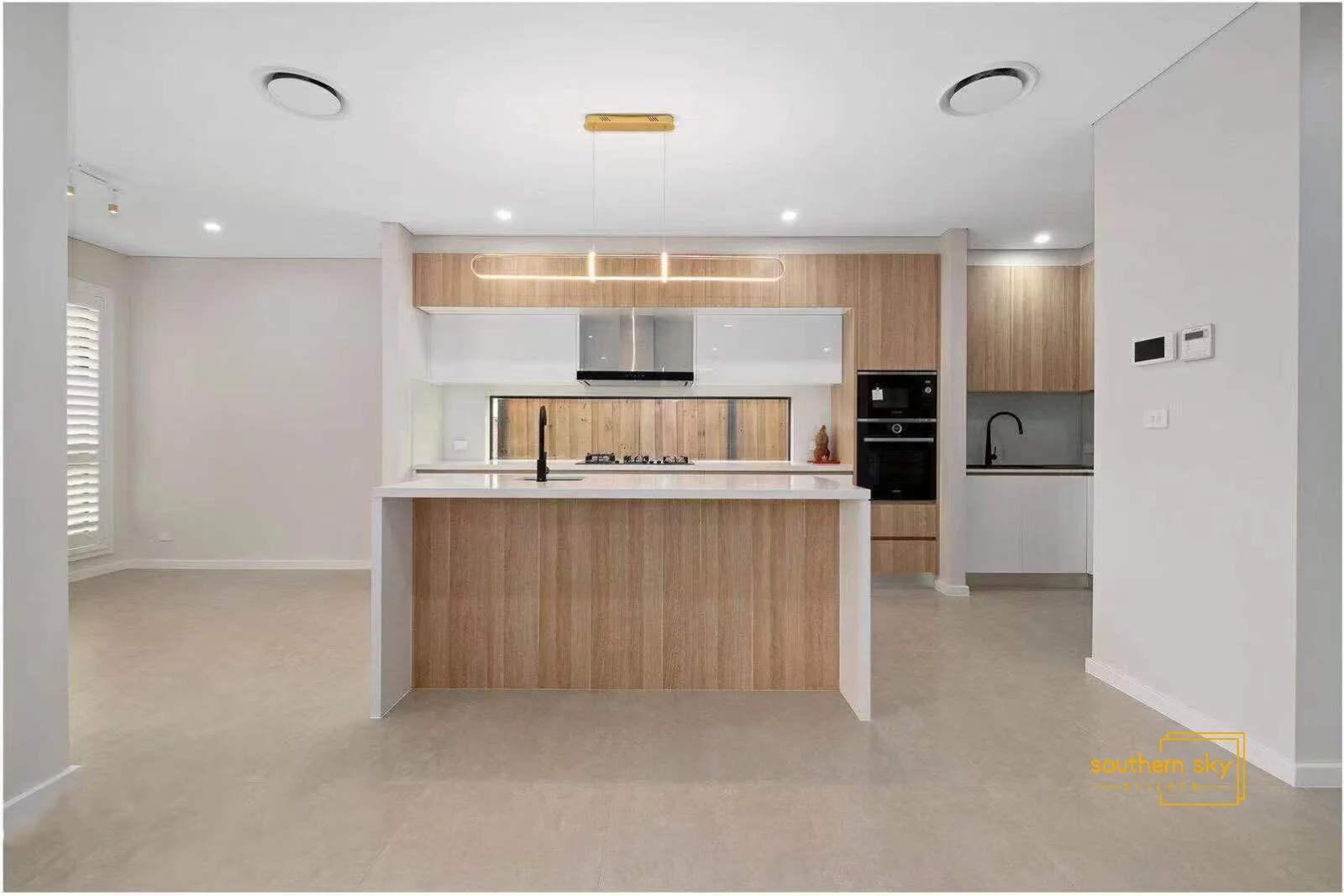 Sleek, modern kitchen design with premium wood cabinetry and elegant fixtures; epitome of craftsmanship and style.