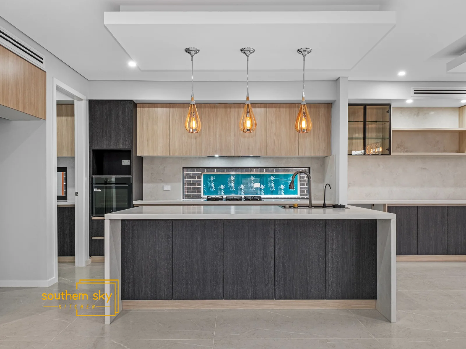 Sleek kitchen design with exquisite craftsmanship, featuring stylish lighting, premium materials, and modern elegance.