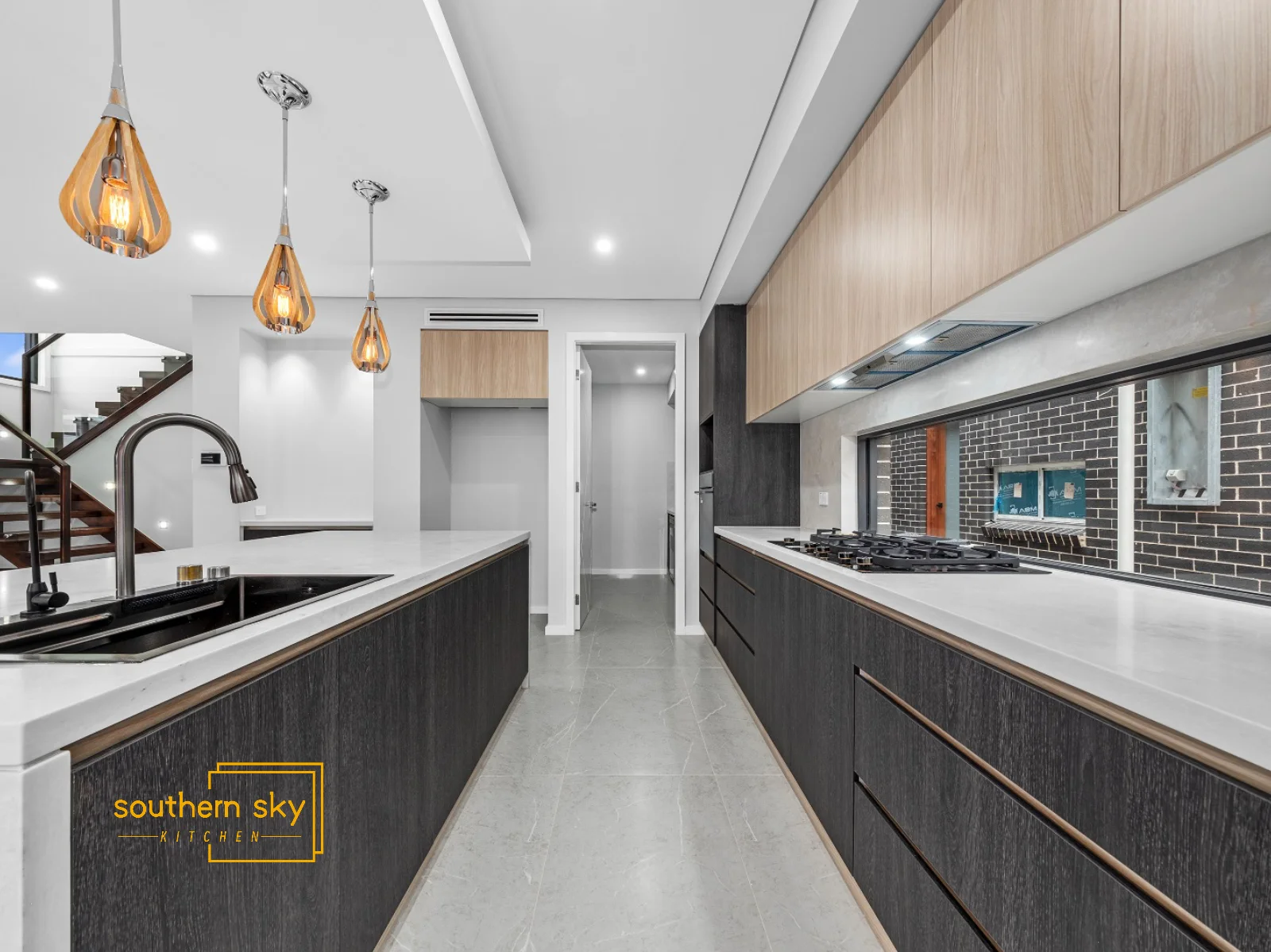 Elegant modern kitchen with premium finishes, sleek cabinetry, and designer lighting; epitome of luxury and craftsmanship.