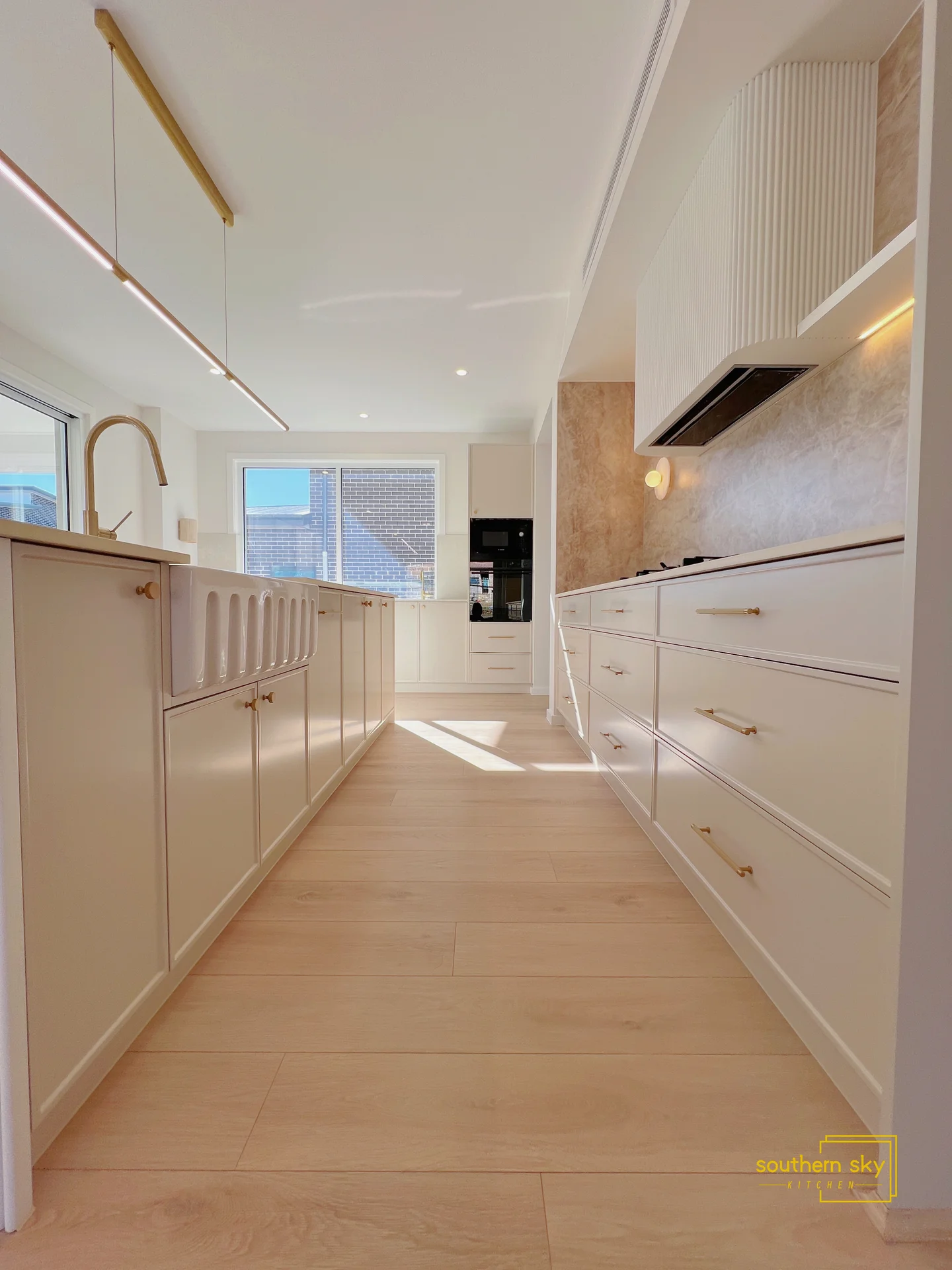 Elegant kitchen with exquisite cabinetry, sleek surfaces, and modern lighting. Expert craftsmanship meets functional design.