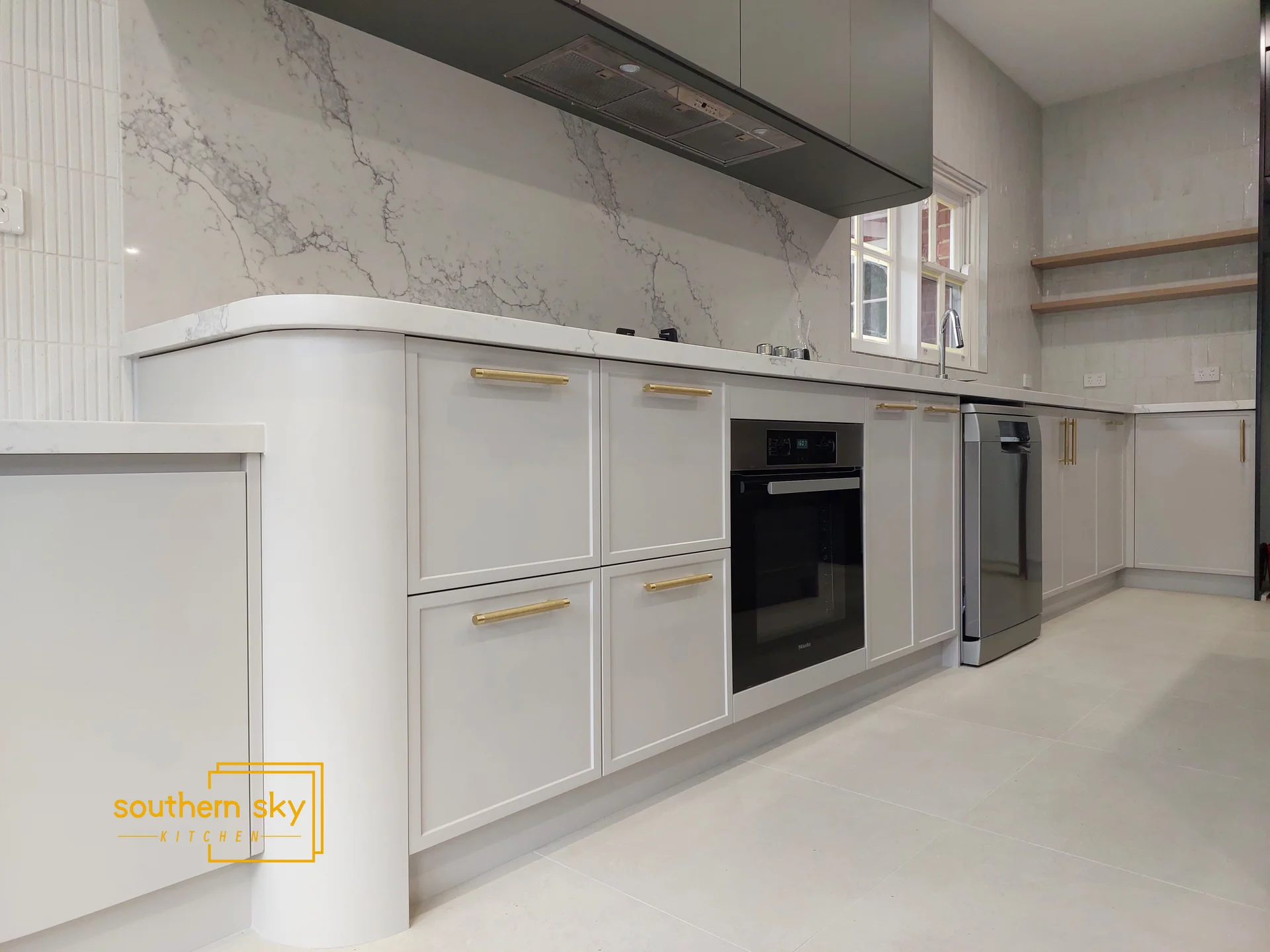 Luxurious kitchen with exquisite marble backsplash and sleek cabinetry. Stunning design meets exceptional craftsmanship.