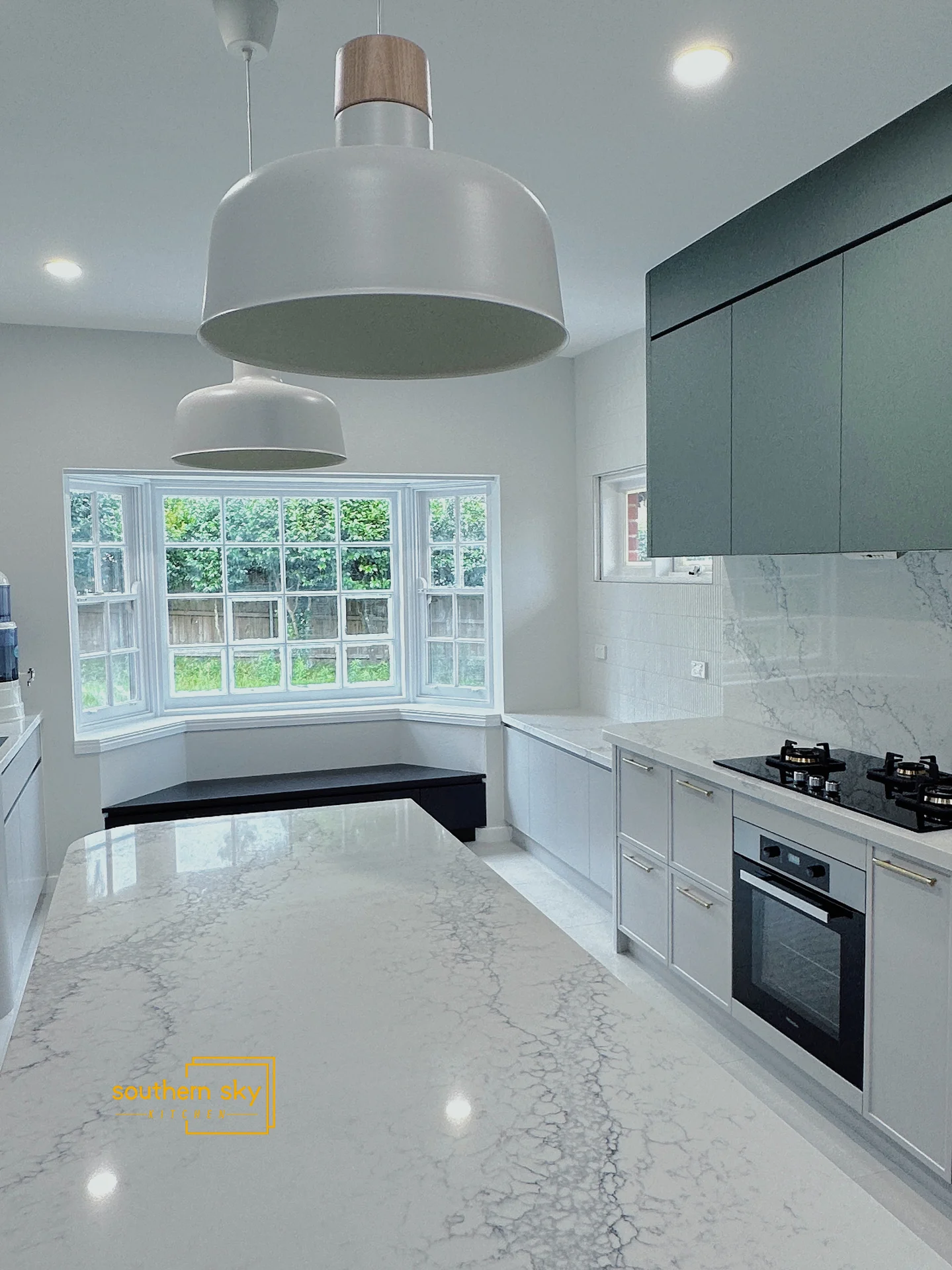 Sleek kitchen design with exquisite marble countertops and modern fixtures, showcasing high craftsmanship and visual elegance.