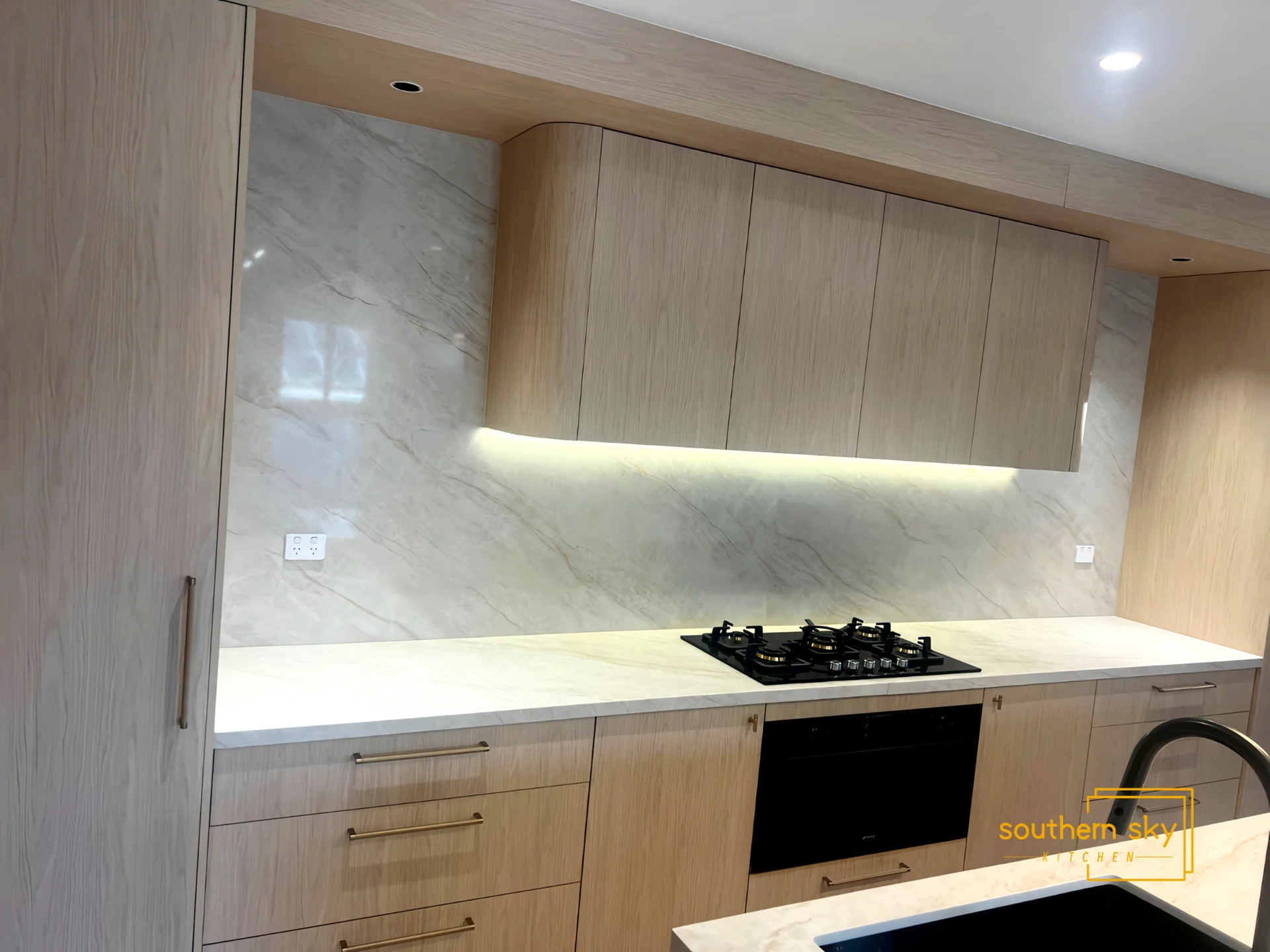 Luxurious kitchen design with exquisite wood cabinetry and sleek marble accents, showcasing premium craftsmanship and style.