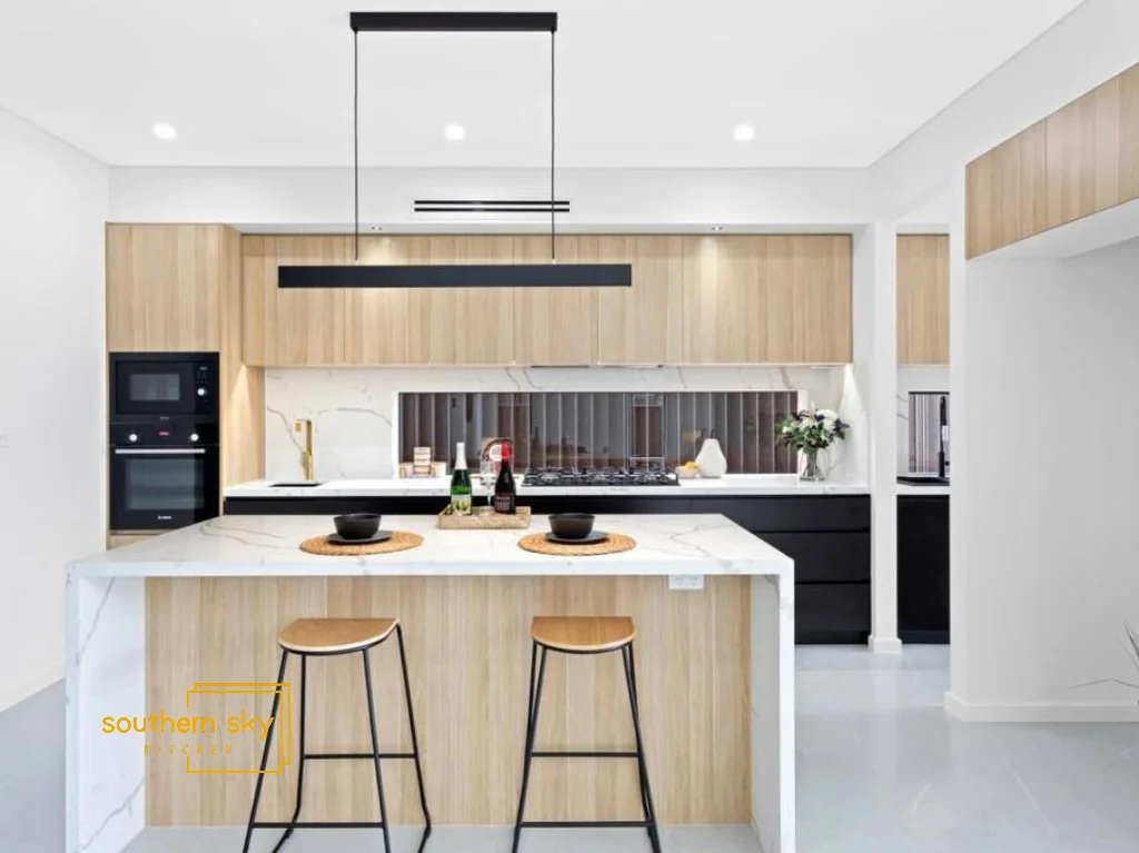 Luxurious modern kitchen with sleek cabinetry and marble island, showcasing exquisite craftsmanship and design excellence.